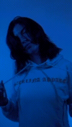 VHS glitch styled video of women in blue sweat shorts and hoodie that say "sterlina apparel" in yellow and man unzipping red bomber jacket. All a part of promotion for streetwear clothing brand Sterlina